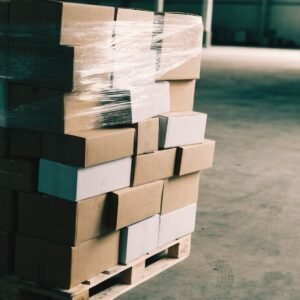 A stretch-wrapped pallet of unbranded mixed cartons on a warehouse floor