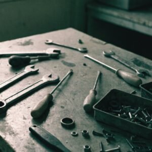 Assorted unbranded hand tools and loose fixings on a workbench